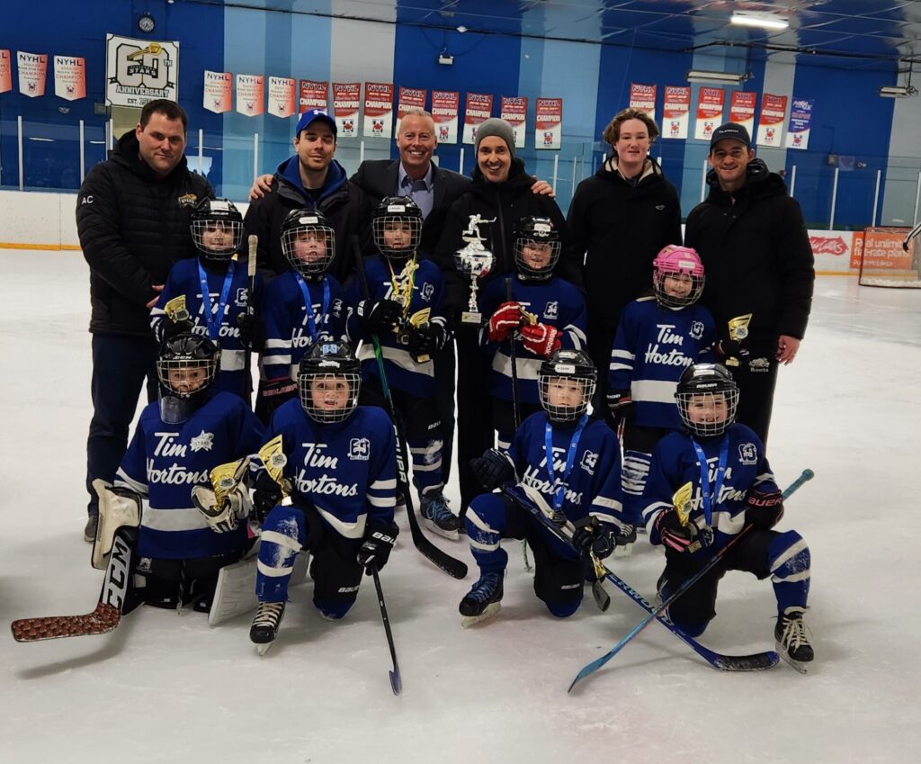 Councillor Burnside presents Timbits Blue with the U9 Championship Trophy